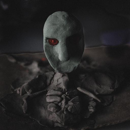 skeleton with red eyed mask face